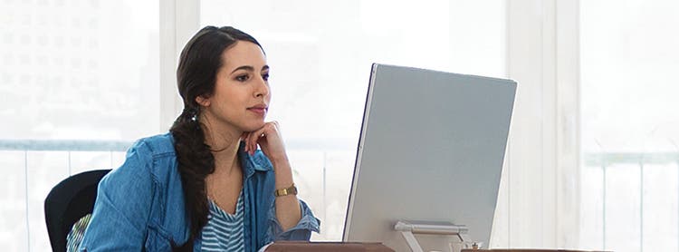 actor portrayal of woman on computer booking appointment