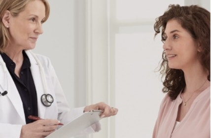 actor portrayal of doctor speaking with woman patient