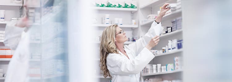 Pharmacist pulling prescription from inventory