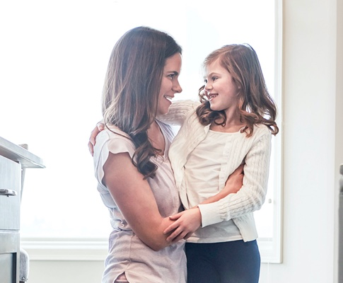 actor portrayal of woman hugging young girl