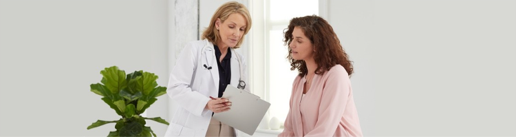 question-to-ask-hero-img actor portrayal of female doctor reading results to a female patient
